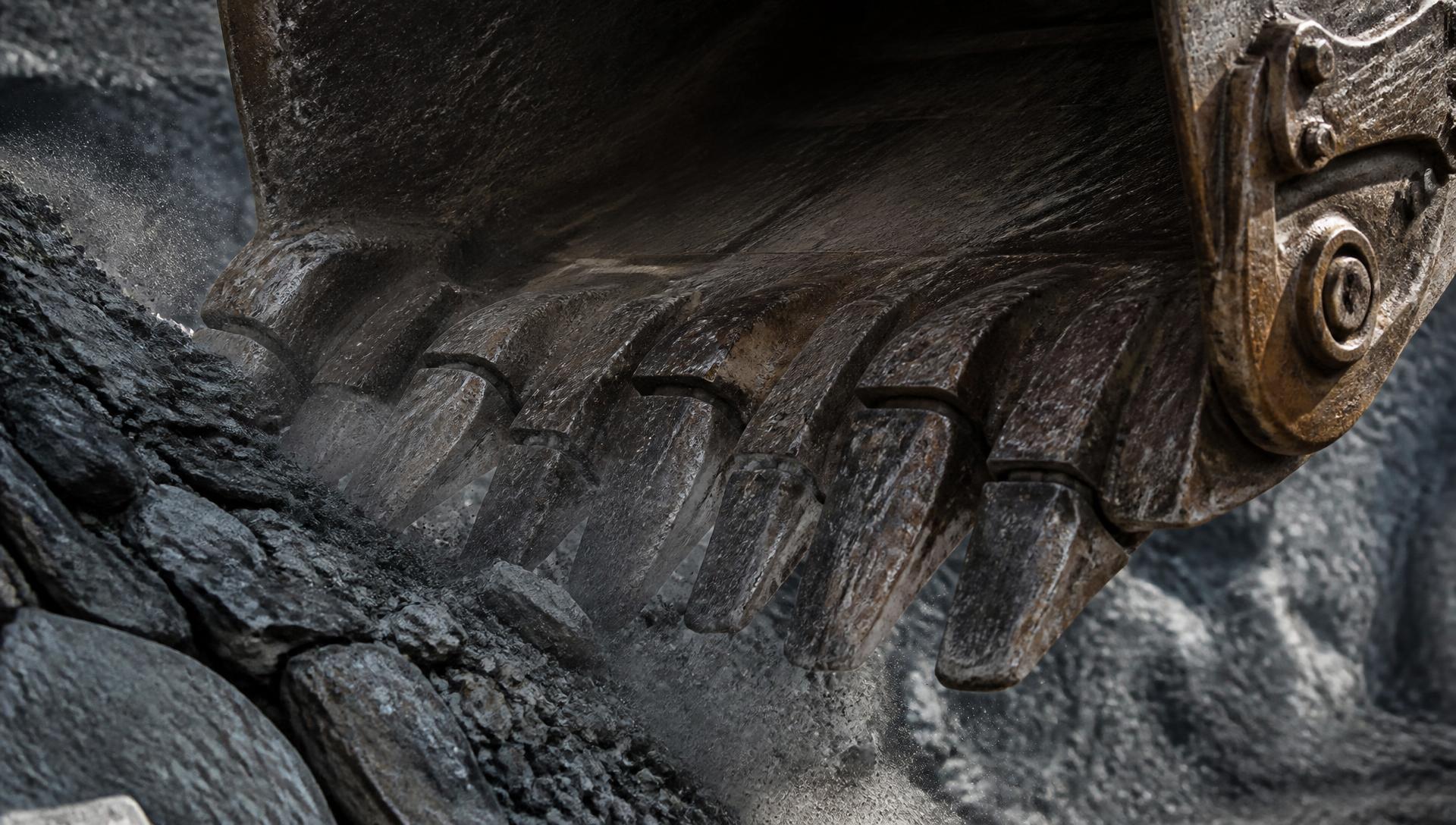 Excavator bucket teeth biting through rock in a quarry